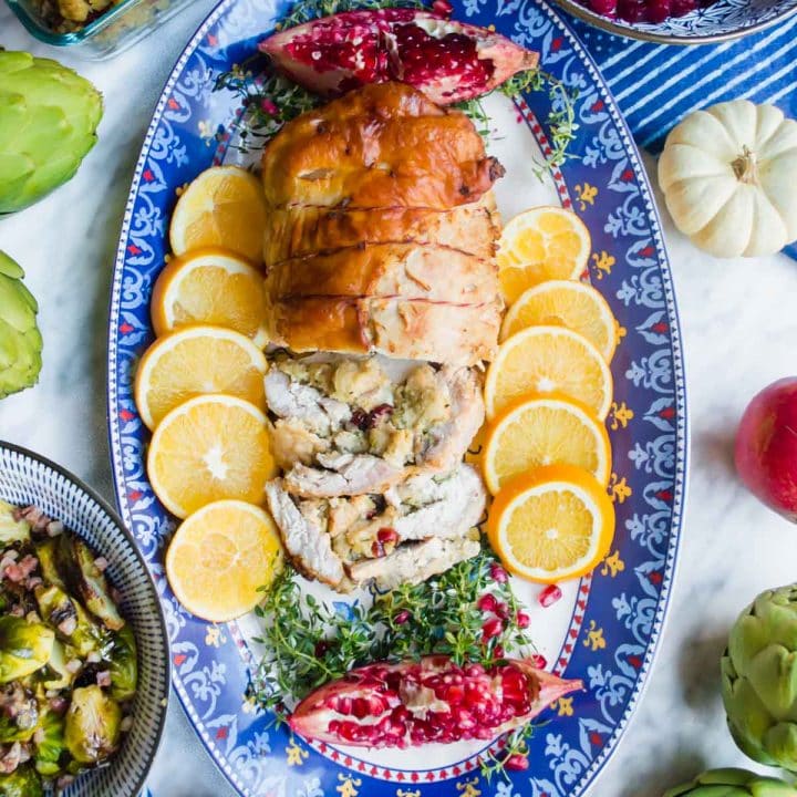 Rolled Turkey Roulade with Cranberry Sauce and other sides flatlay.