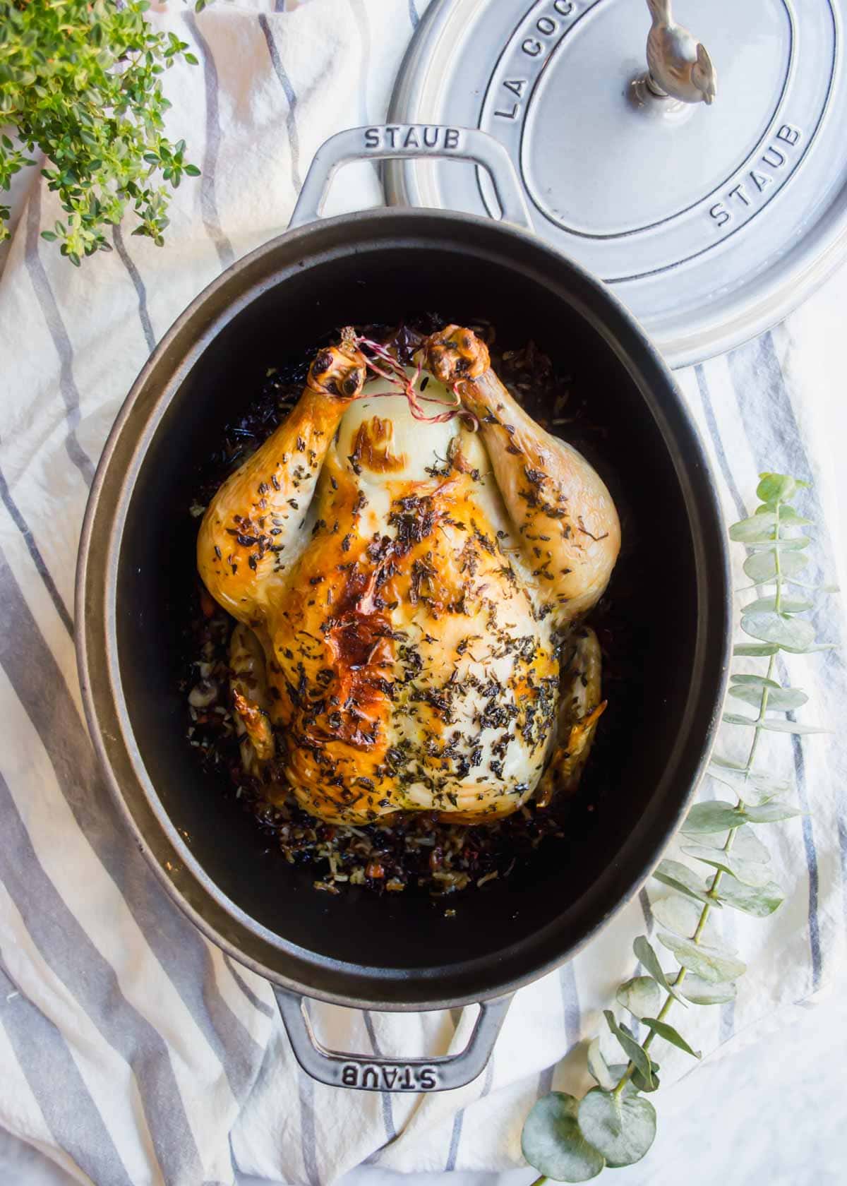 Roasted Chicken Stuffed with Wild Rice in dutch oven.