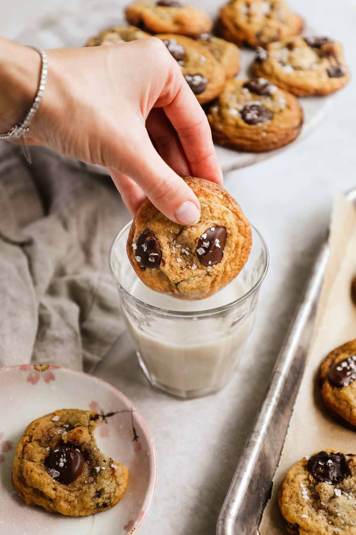 Classic crispy chewy chocolate chip walnut cookies dipped in a glass of milk.
