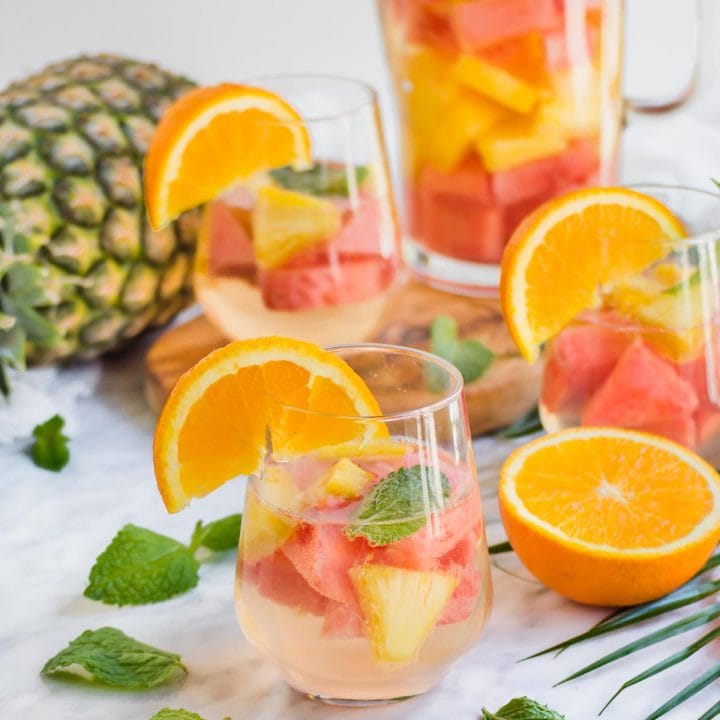 Pineapple Watermelon Summer Sangria in glass and pitcher.