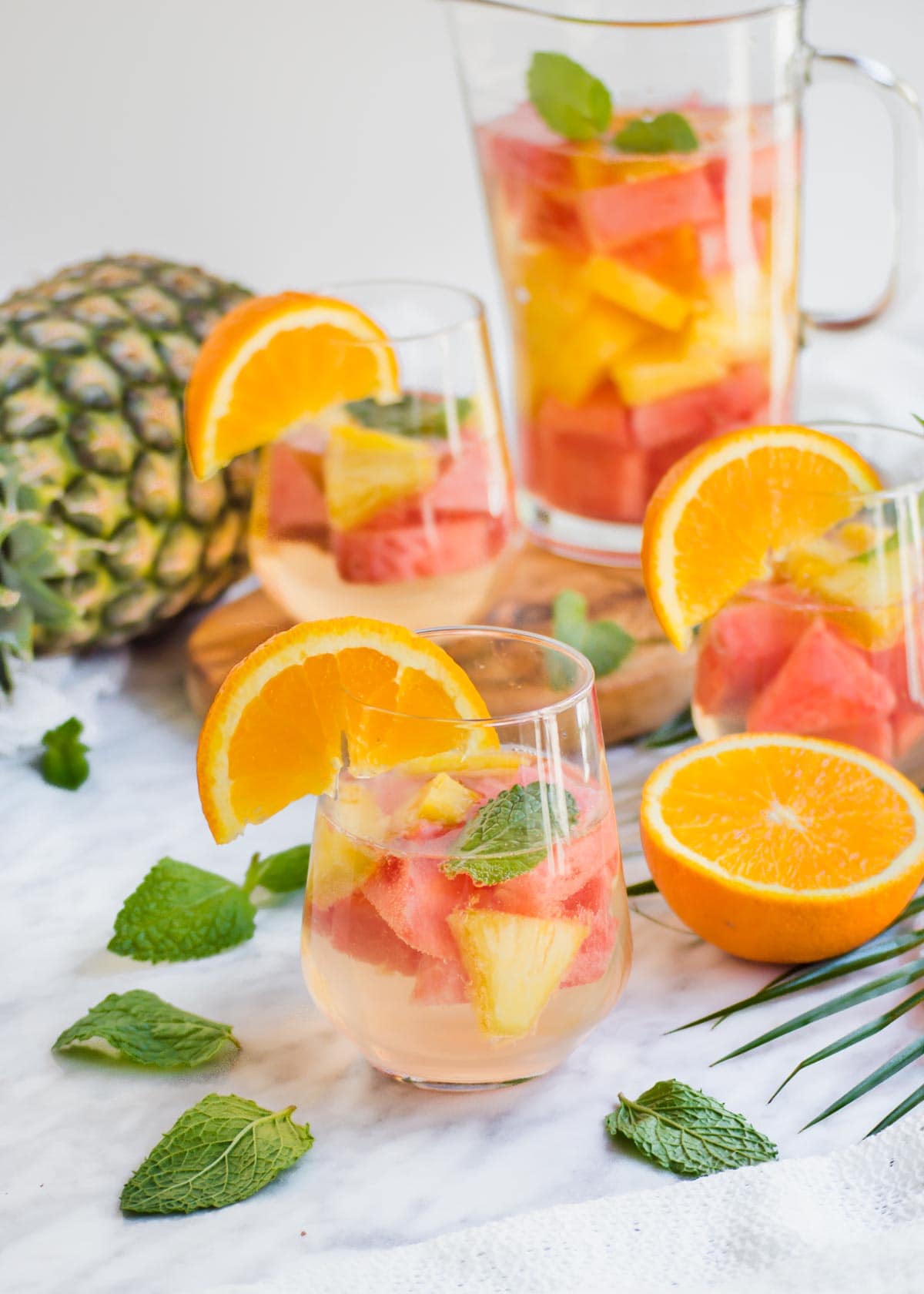 Pineapple Watermelon Summer Sangria in glass and pitcher.