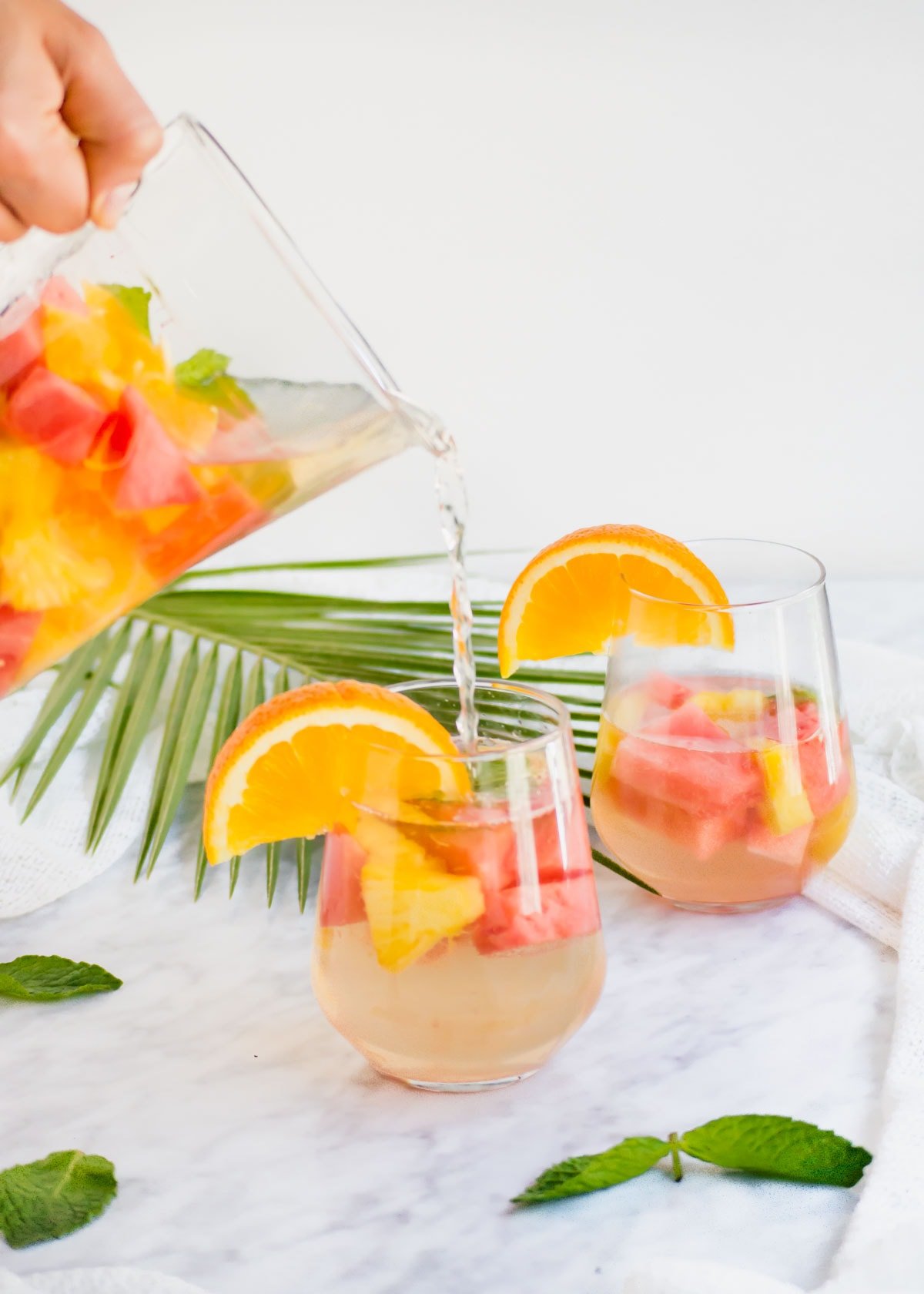 Pineapple Watermelon Summer Sangria poured into glass.