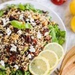 Harvest Salad with Quinoa and Arugula and lemon slices on plate.