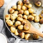potatoes roasting in a pan with spoon