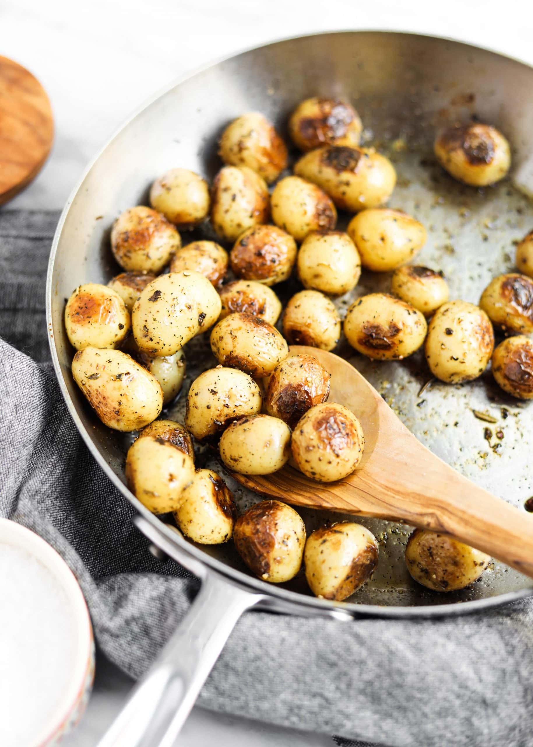 potatoes roasting in a pan with spoon