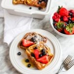 Easy Brioche French Toast on plate with bowl of berries