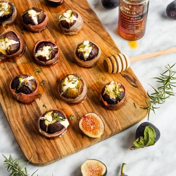 Prosciutto-Wrapped Figs with Goat Cheese Appetizer on serving board.