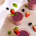 Peanut Butter and Berry Smoothie in glass cups with strawberries and mint