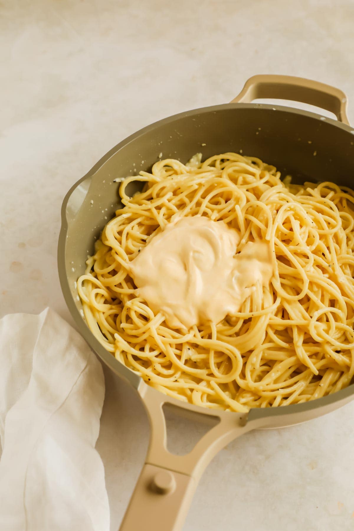 Sea urchin and creme fraiche cream on top of pasta in a pan