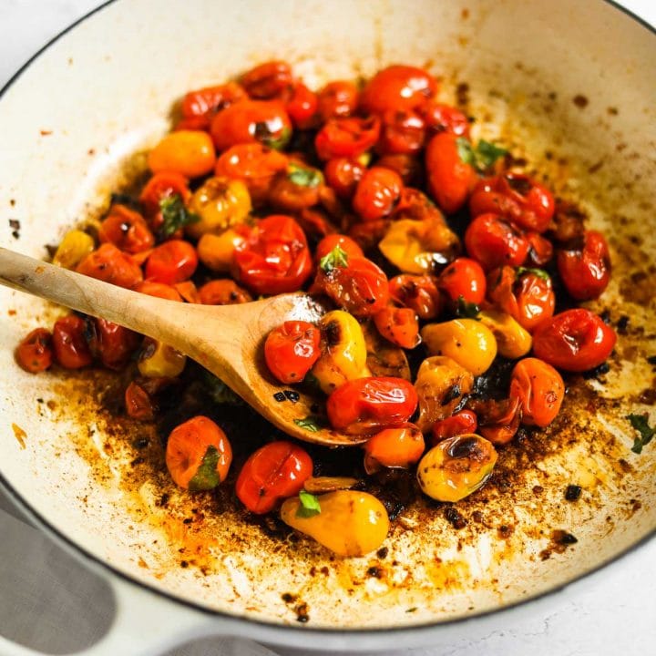 Blistered Cherry Tomatoes with olive wood spoon and Le Creuset White Braiser.