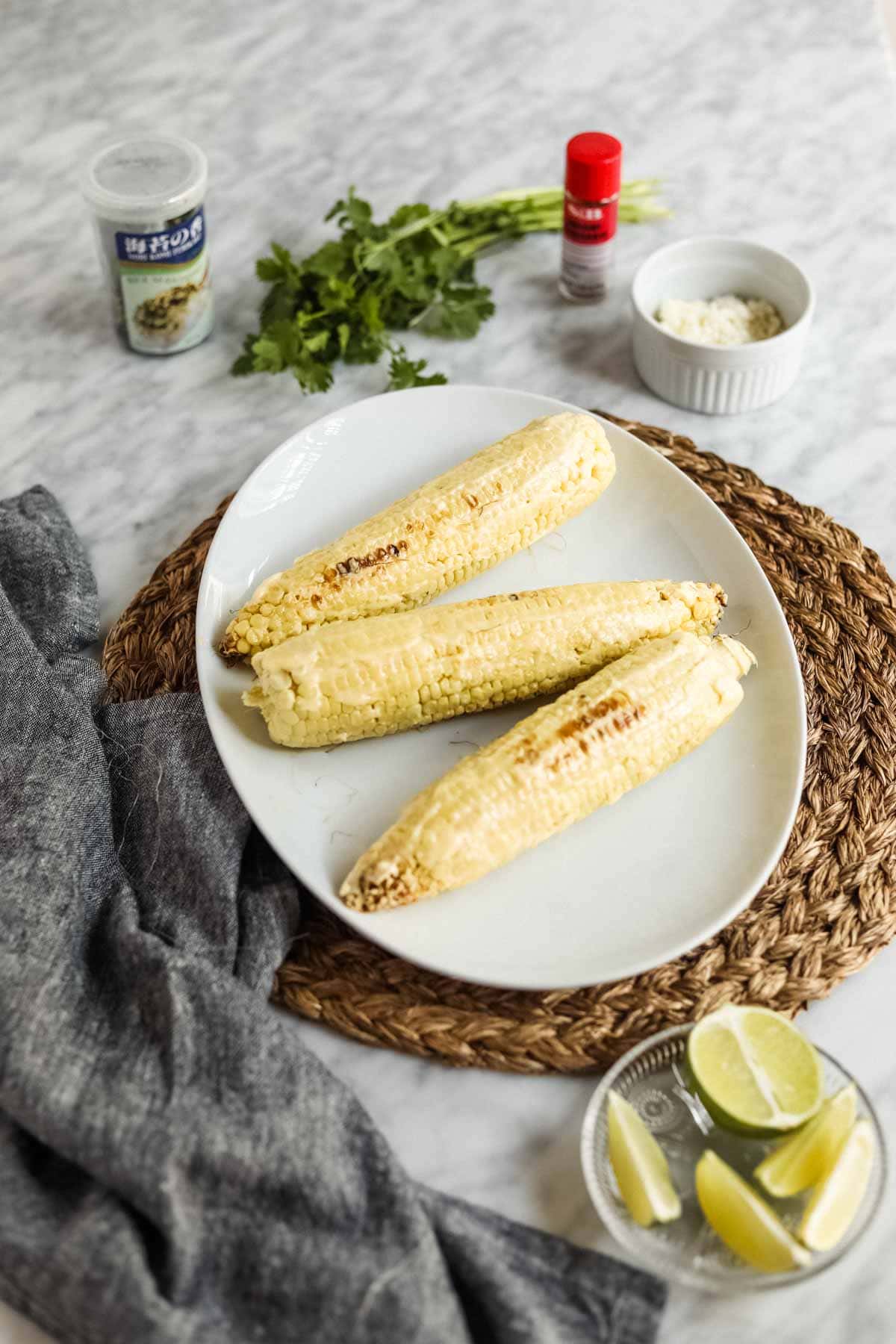 Elote-style corn with kewpie mayo and limes.