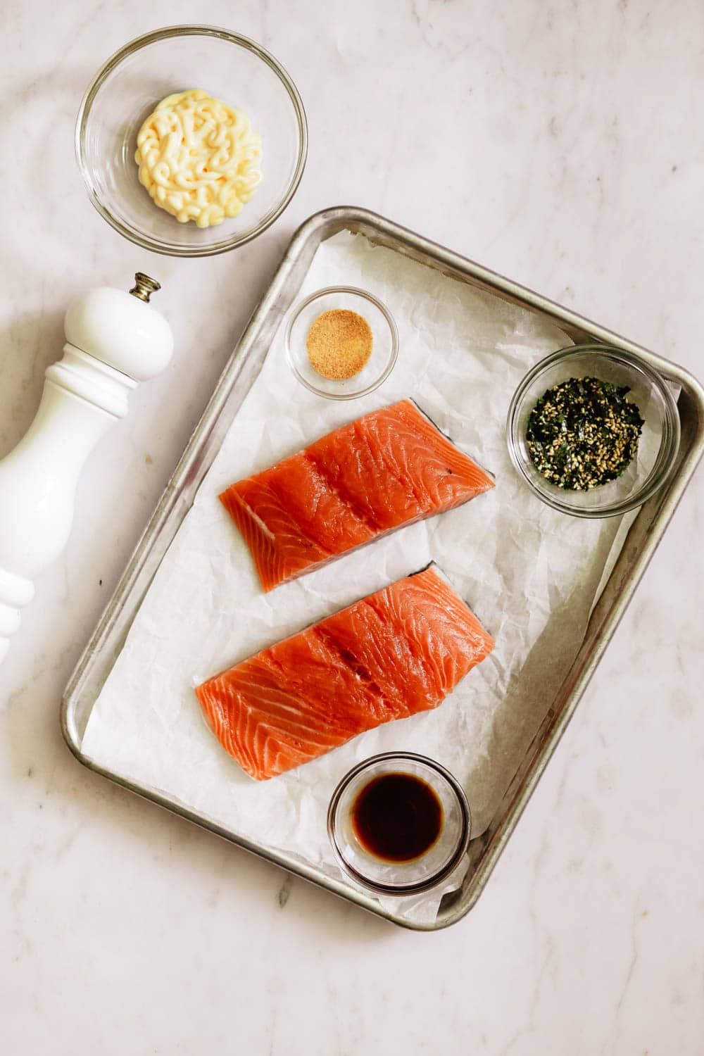 Ingredients for Furikake Salmon, with salmon filets, garlic powder, soy sauce, furikake, kewpie mayo, and black pepper.