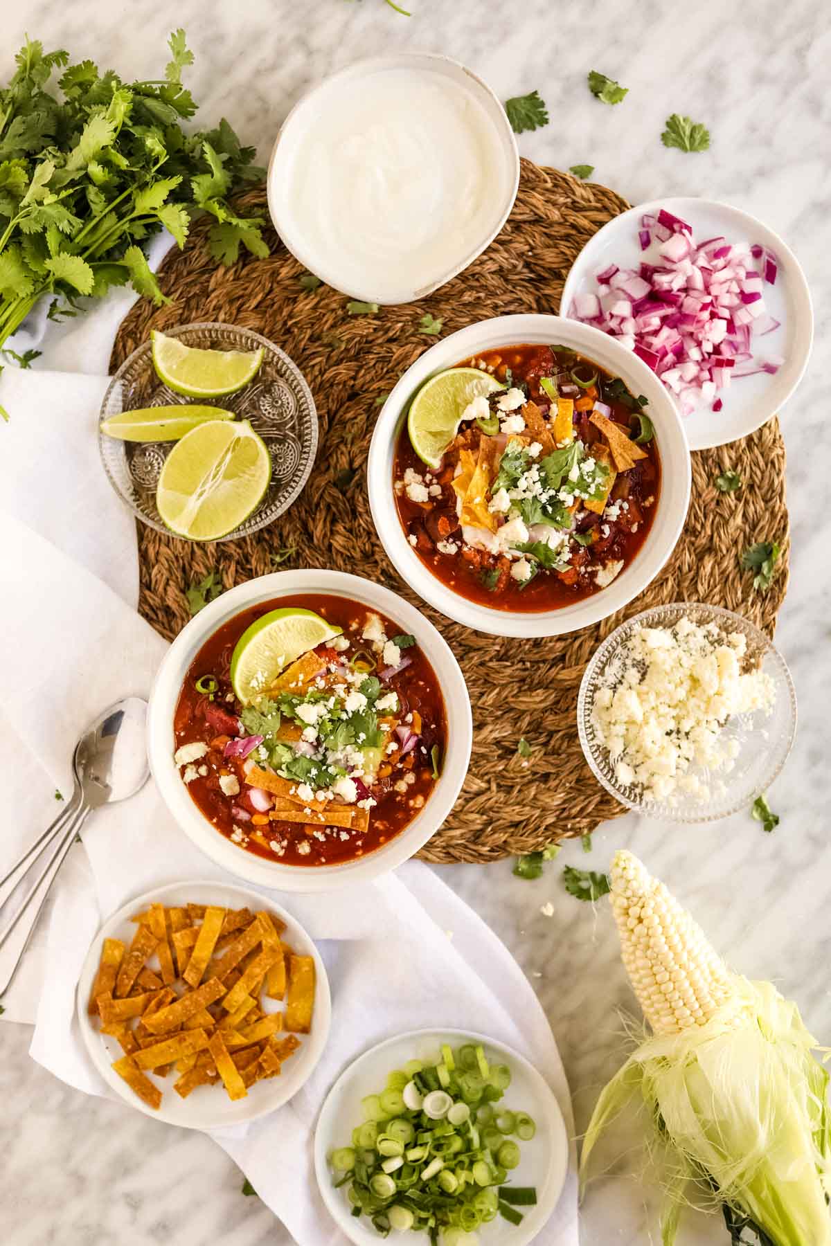 Healthy Turkey Chili in bowls with toppings flatly.