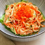 Closeup of Spicy Kani Salad with tobiko and panko in a blue Japanese bowl.