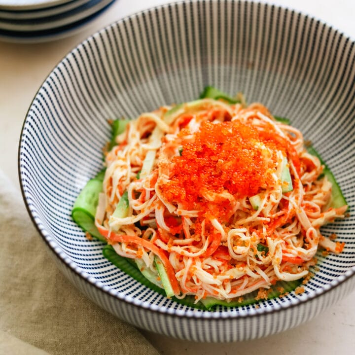 Closeup of Spicy Kani Salad with tobiko and panko in a blue Japanese bowl.