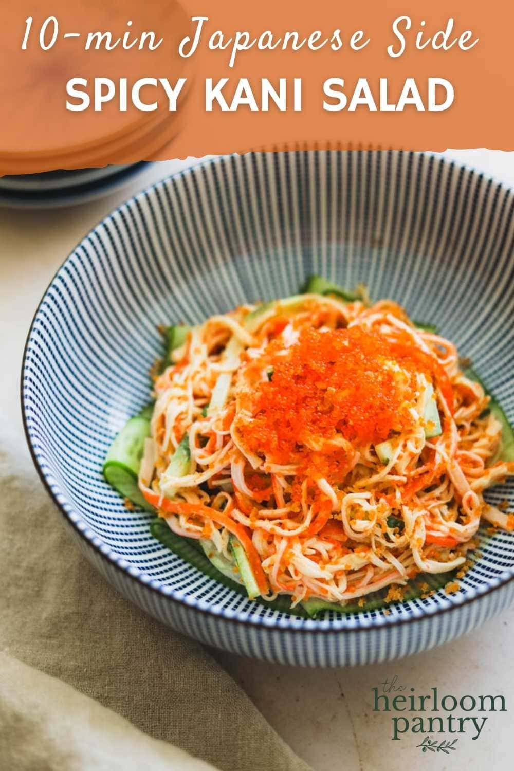 Spicy Kani Salad with tobiko and panko bread crumbs in a blue Japanese striped bowl for Pinterest.