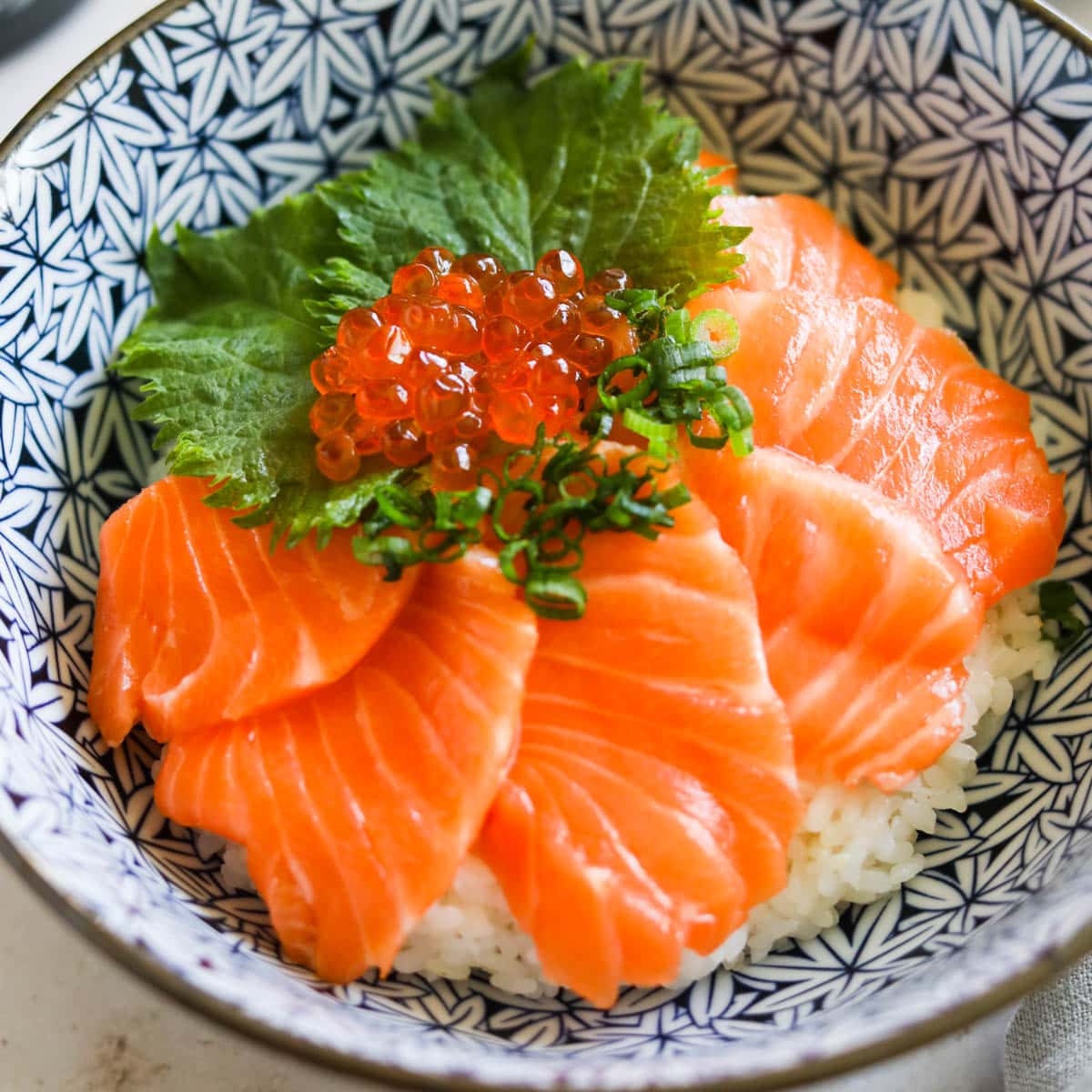 Closeup of salmon sashimi rice bowl with Ikura.