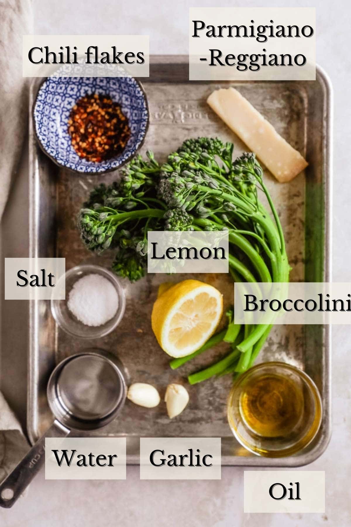 Ingredients to make broccolini, including salt, pepper, garlic, oil, chili flakes, and lemon.