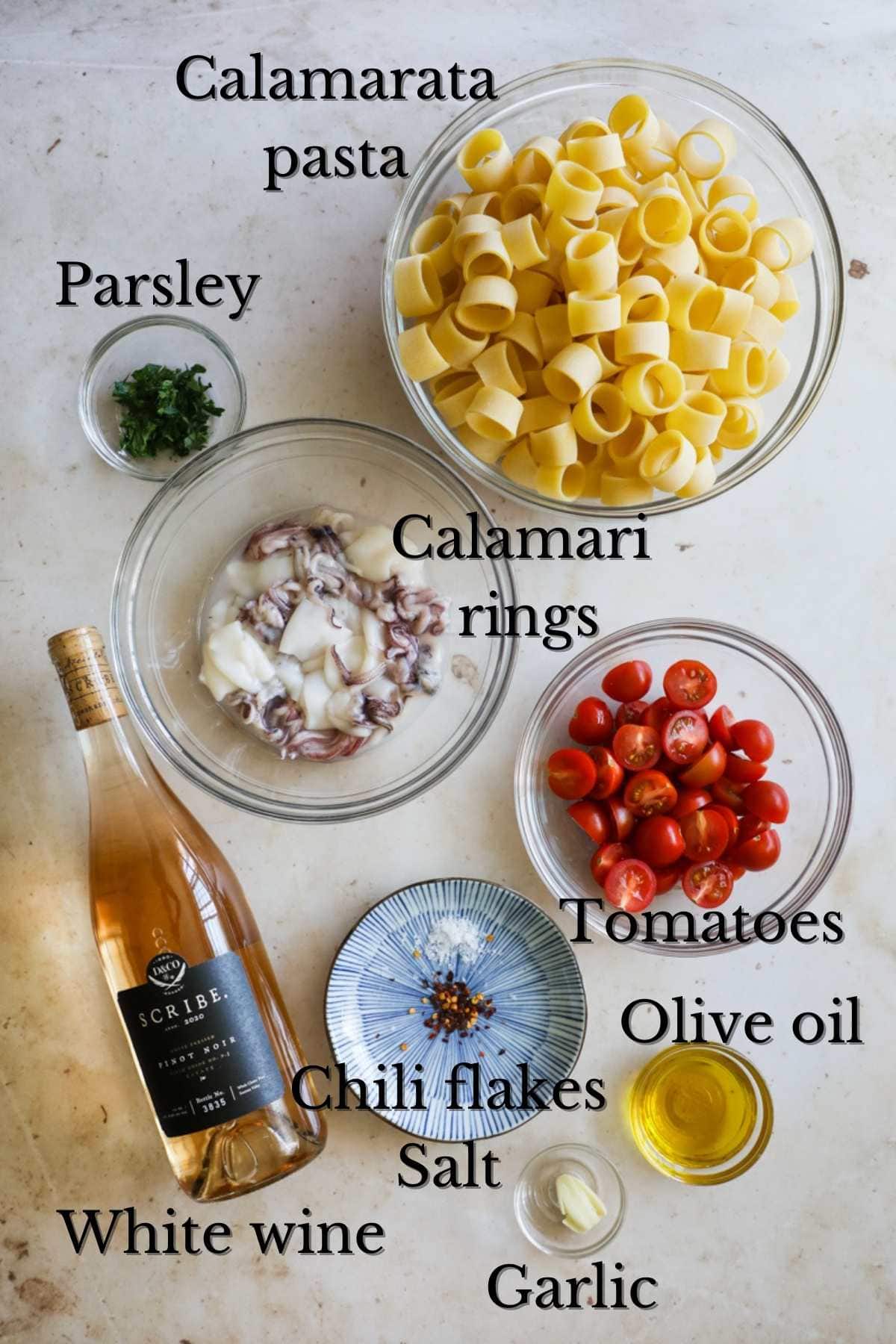 Ingredients to make Calamarata (calamari and tomato) pasta.