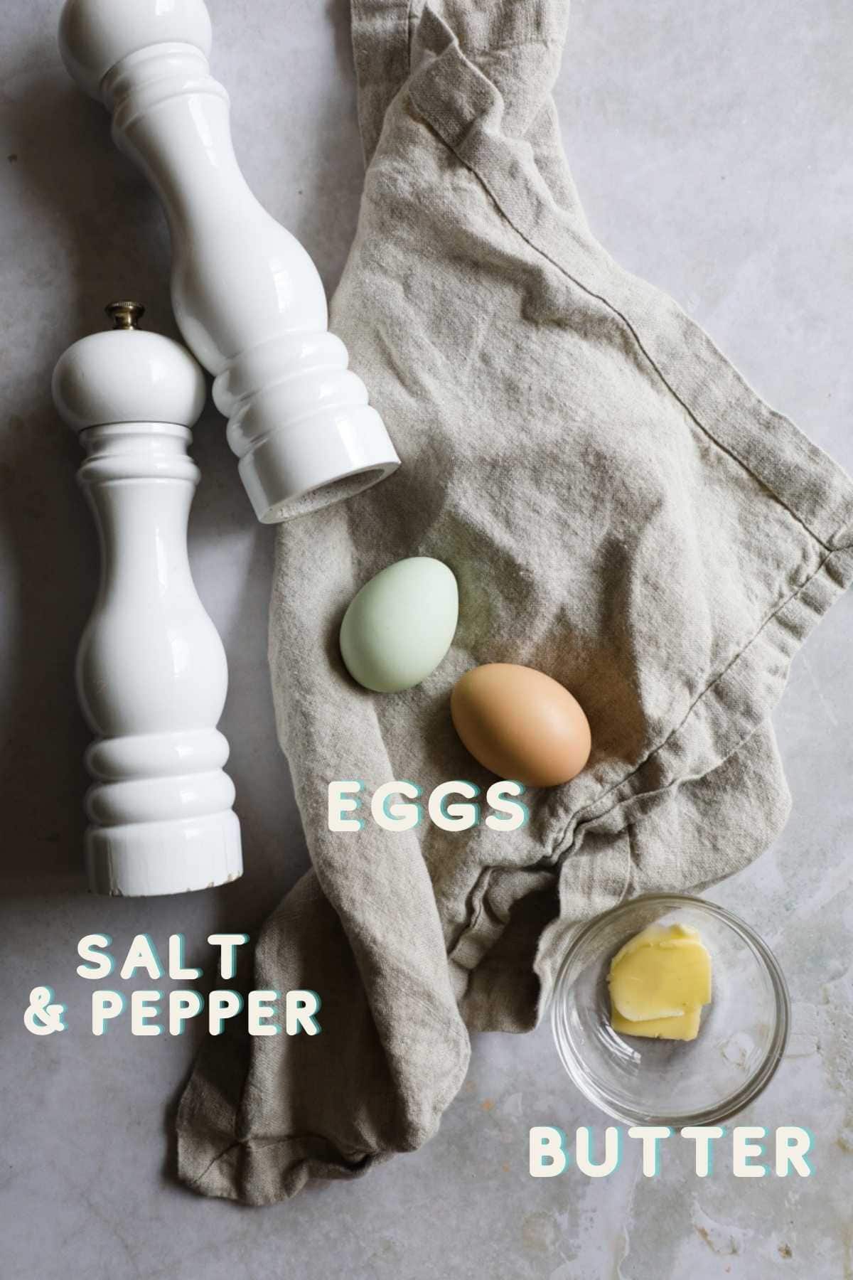 Ingredients to make sunny side up eggs, including pasture raised eggs, butter, salt, and pepper.