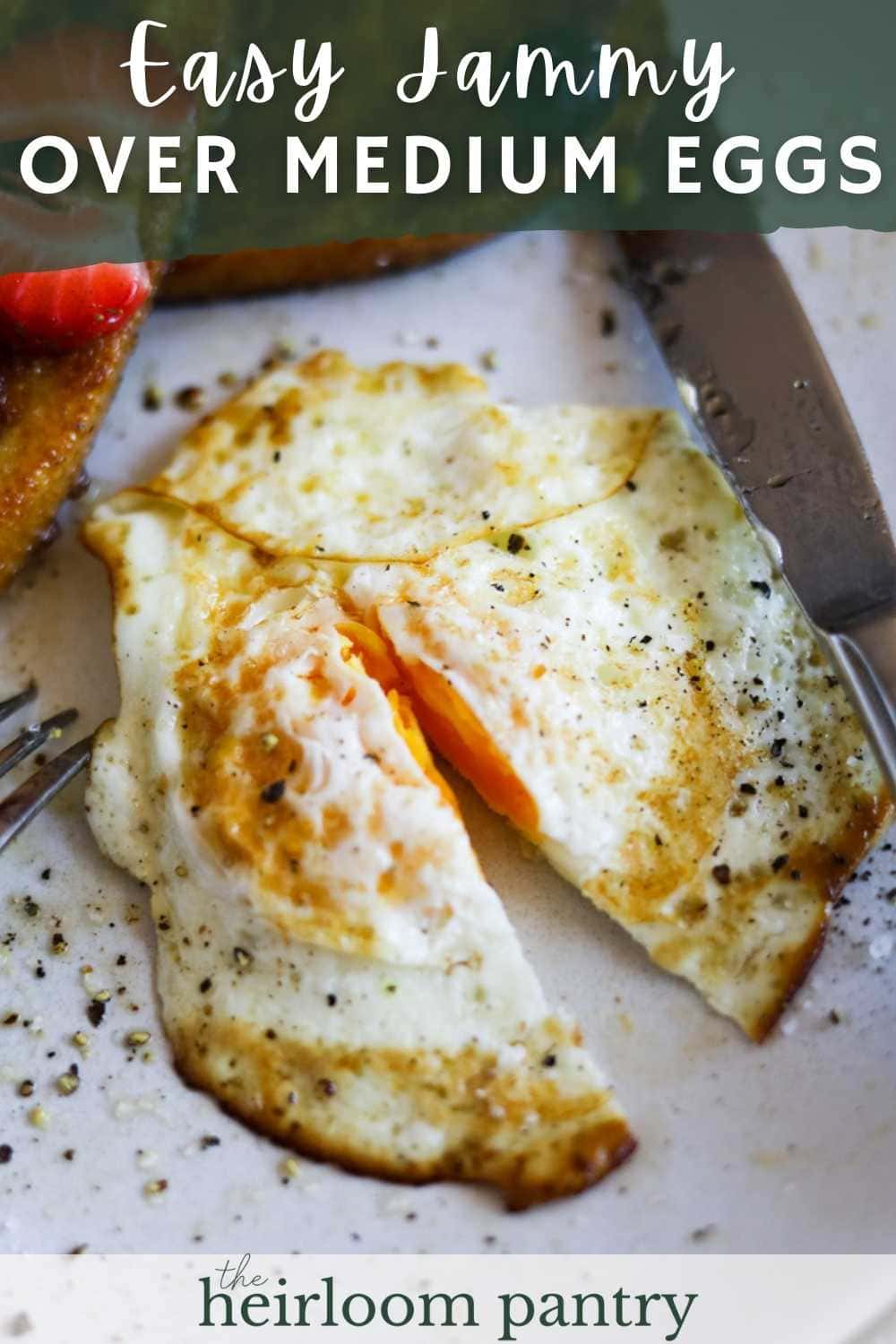 Over medium eggs with butter, salt, and pepper on a plate Pinterest pin.