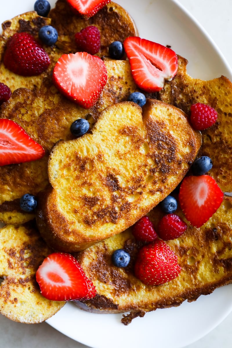 Closeup shot of sourdough French toast with berries on a platter.
