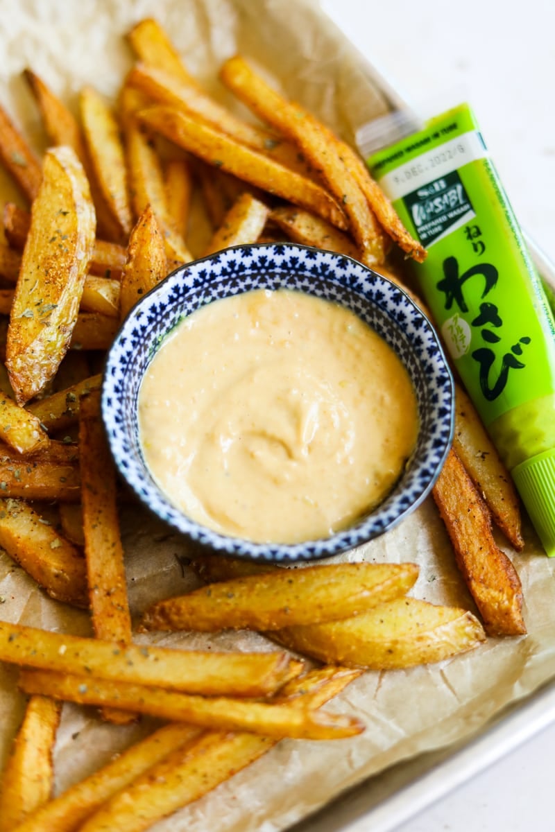 Wasabi mayo aioli sauce in a blue bowl with fries.