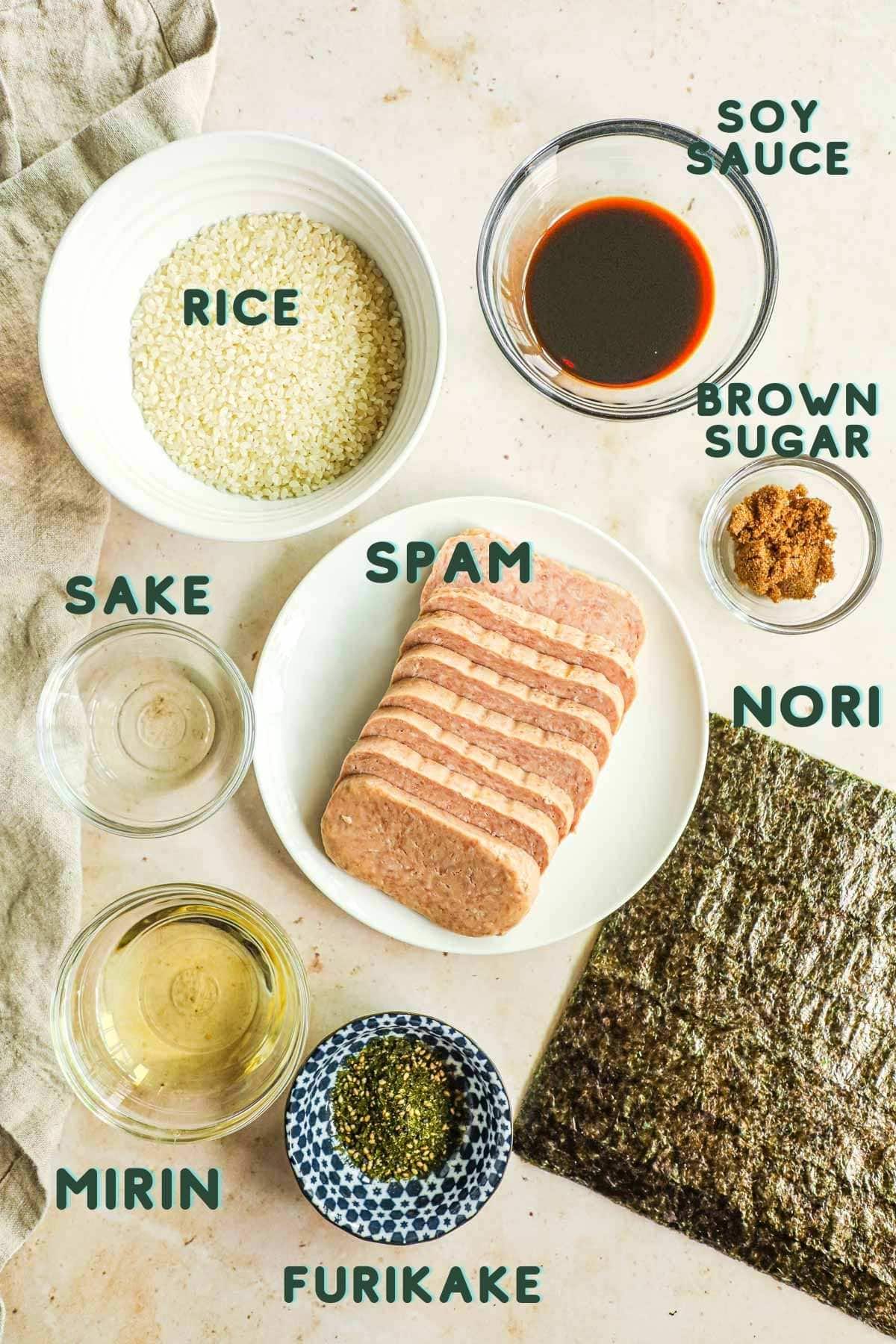 Ingredients to make teriyaki Spam musubi, including rice, shoyu, spam, brown sugar, nori, furikake, mirin, and sake.
