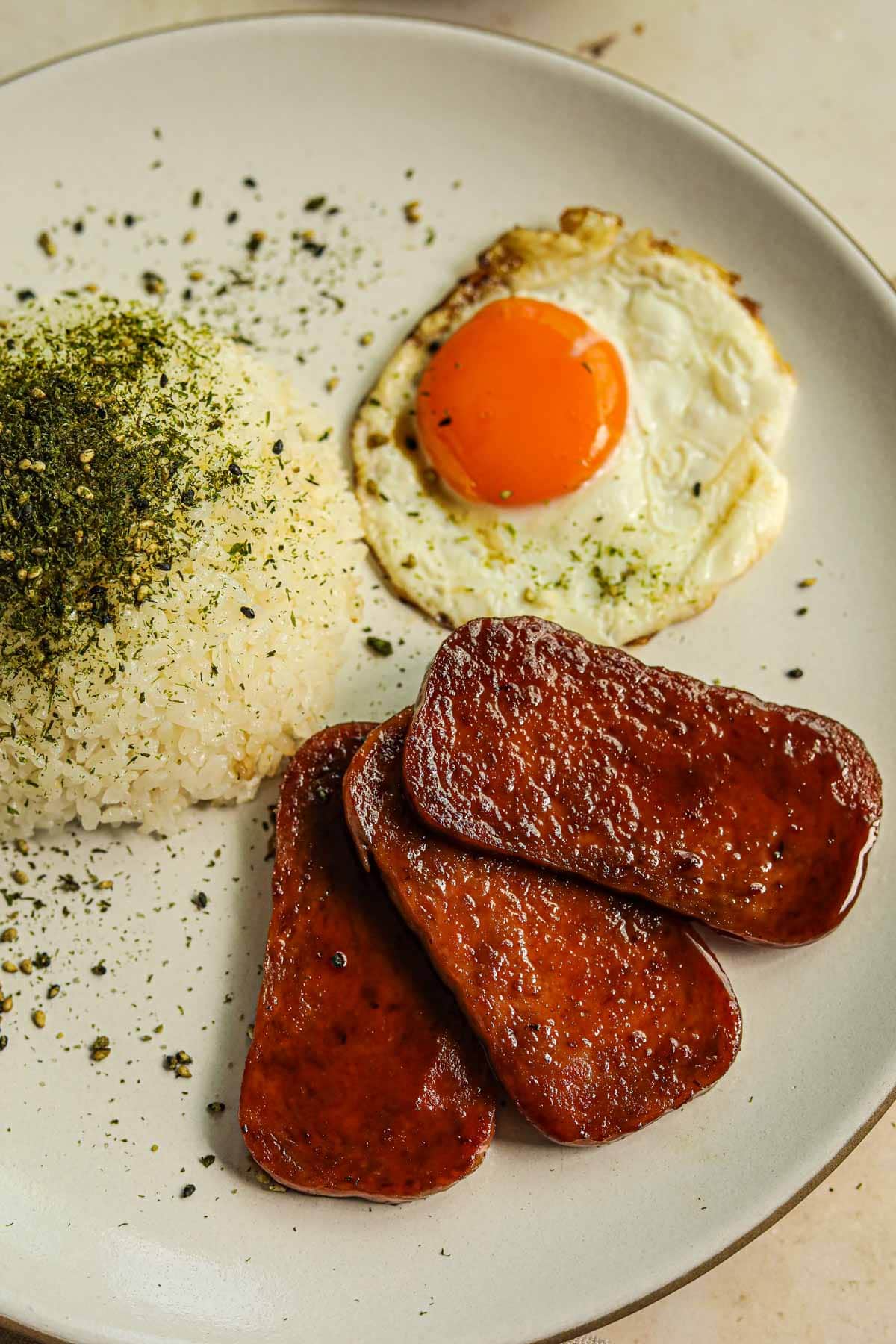 Yolky egg, rice, and fried Spam with homemade teriyaki sauce.