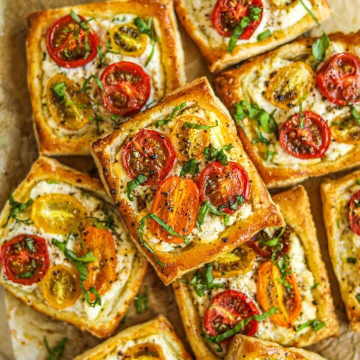 Closeup shot of ricotta tomato tartlets with puff pastry.