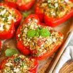 Closeup photo of turkey and quinoa stuffed peppers with feta, spinach, tomatoes, and basil.