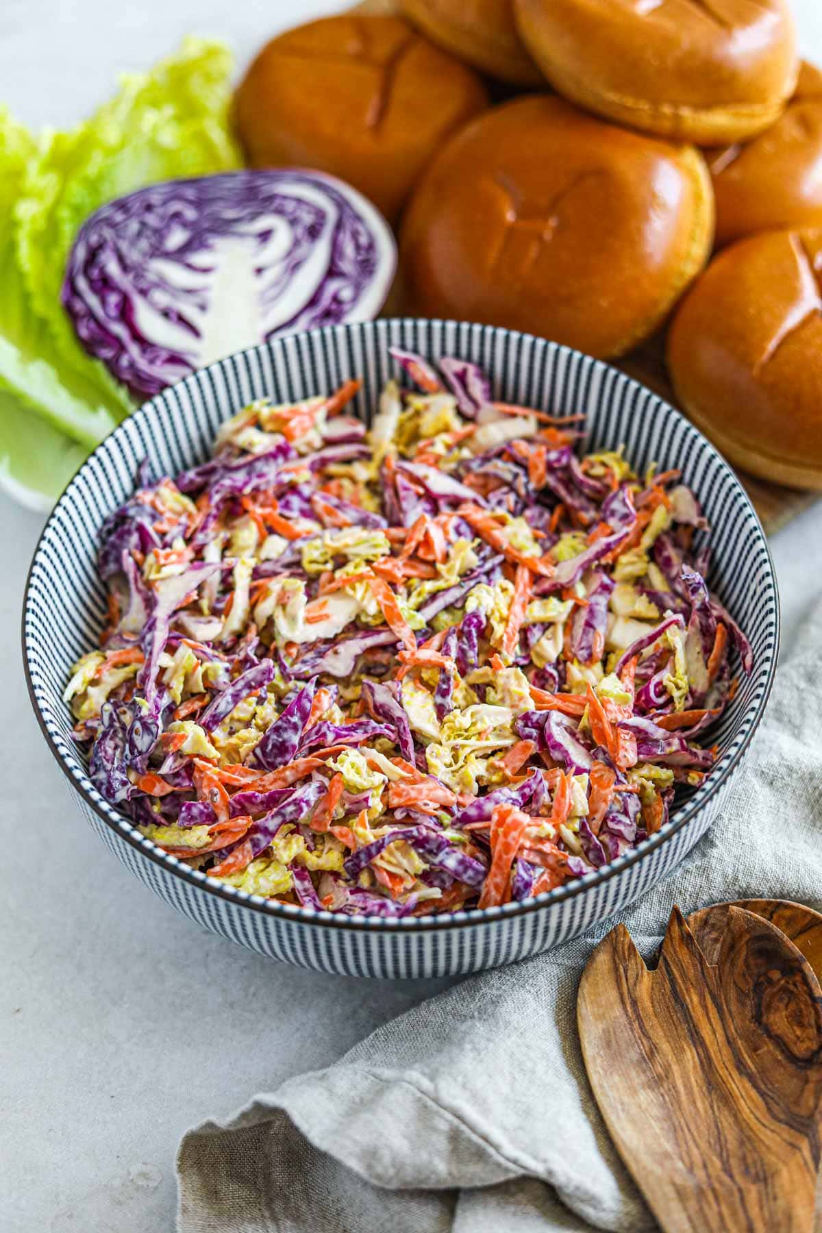 Healthy Greek Yogurt Coleslaw recipe (with Napa and Red Cabbage) in a striped Japanese bowl.