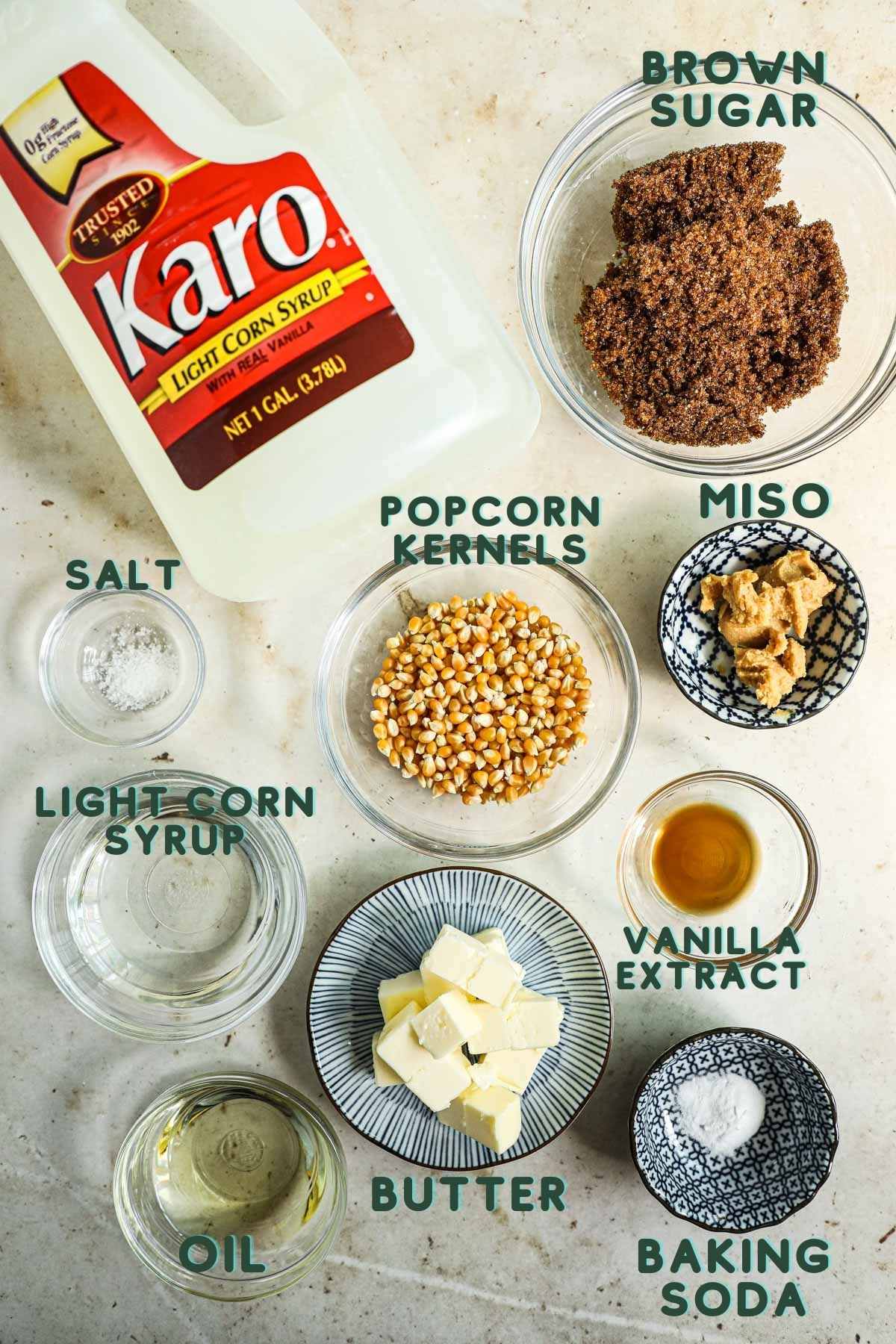 Ingredients to make miso caramel corn, including popcorn kerbels, miso, brown sugar, Karo light corn syrup, salt, butter, vanilla extract, baking soda, miso paste.