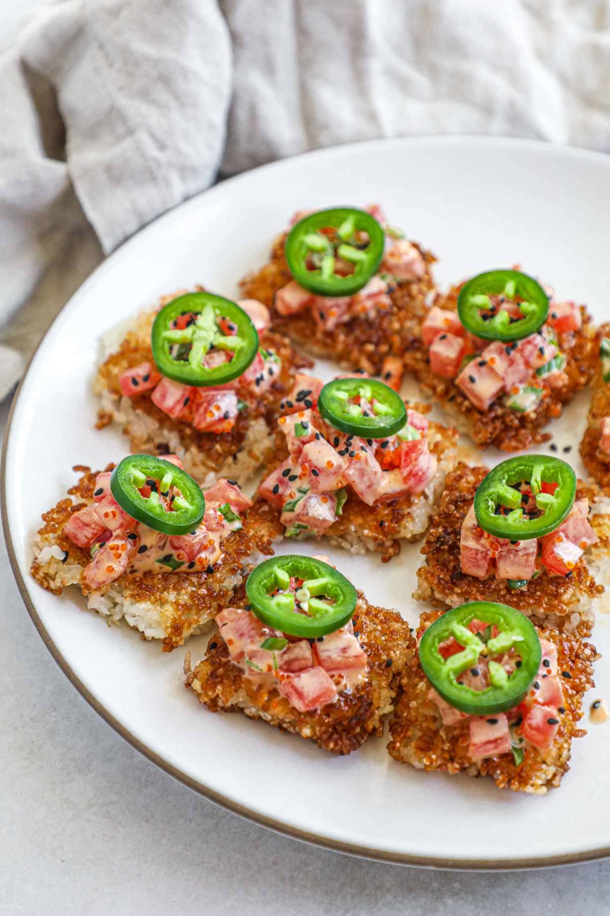 Spicy tuna with crispy rice and jalapeño on a serving platter.