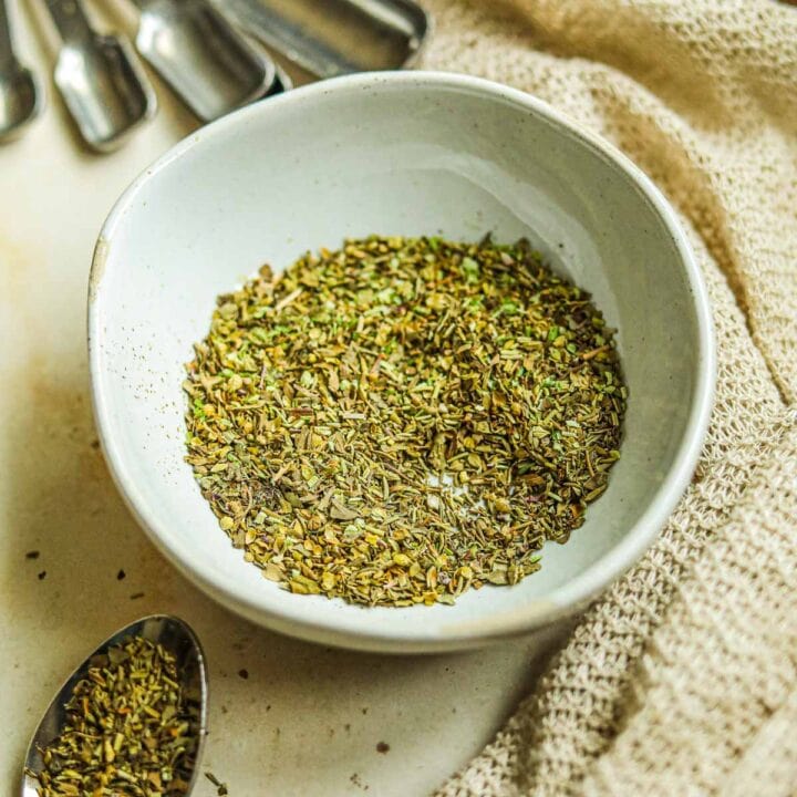 Italian seasoning substitute with dried basil, parsley, thyme, rosemary, and oregano in a bowl.