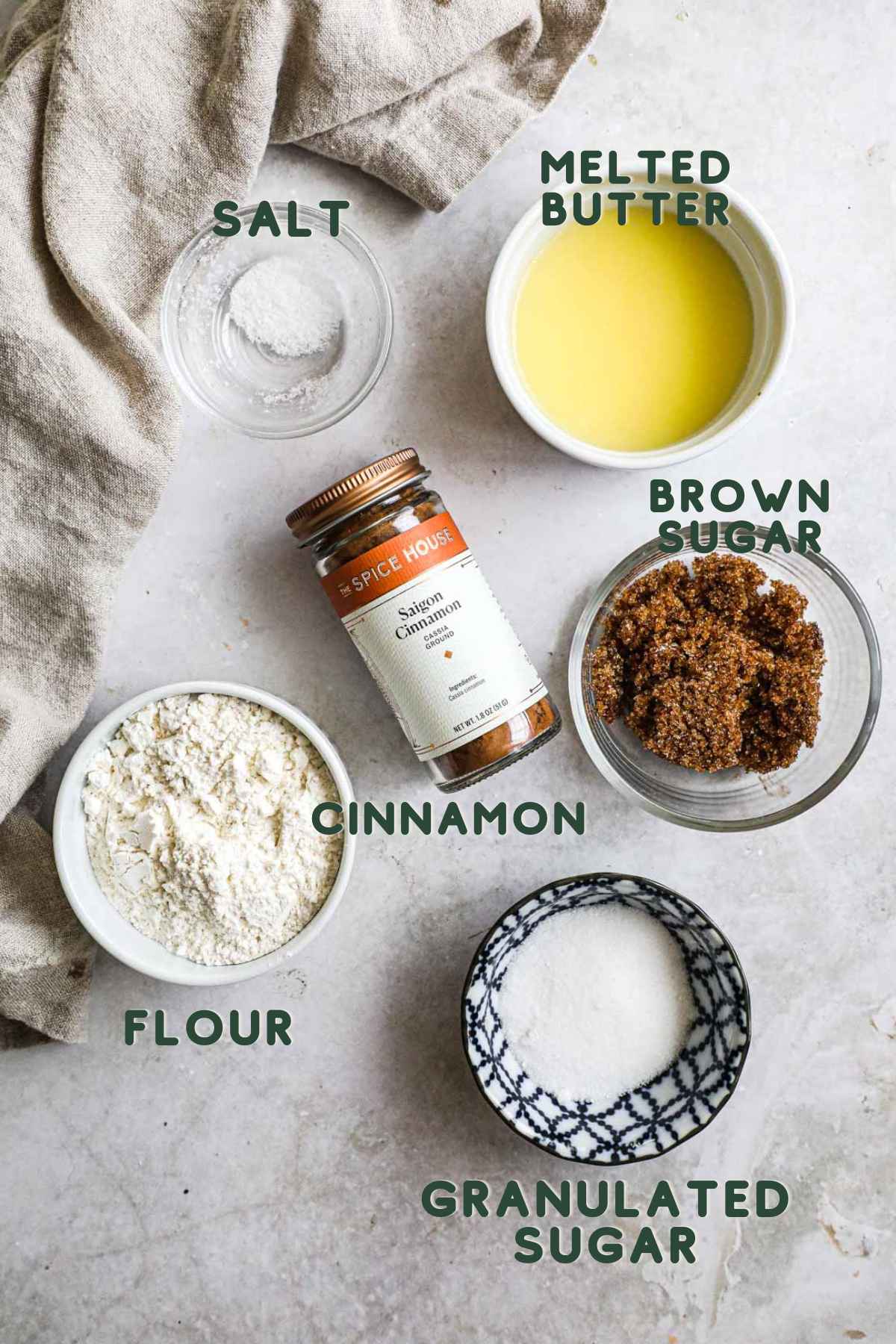 Ingredients to make easy butter streusel crumb topping, including salt, melted butter, cinnamon, brown sugar, granulated sugar, and flour.