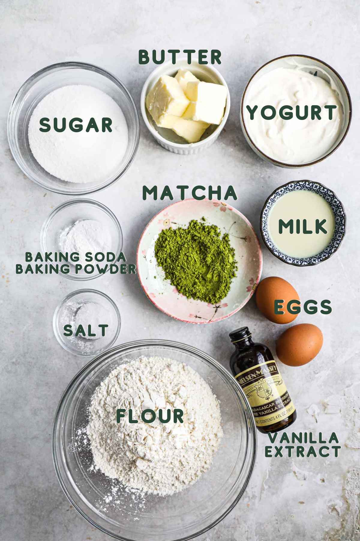 Ingredients to make matcha cinnamon streusel muffins, including butter, yogurt, milk, eggs, vanilla, flour, sugar, salt, baking powder, and baking soda.