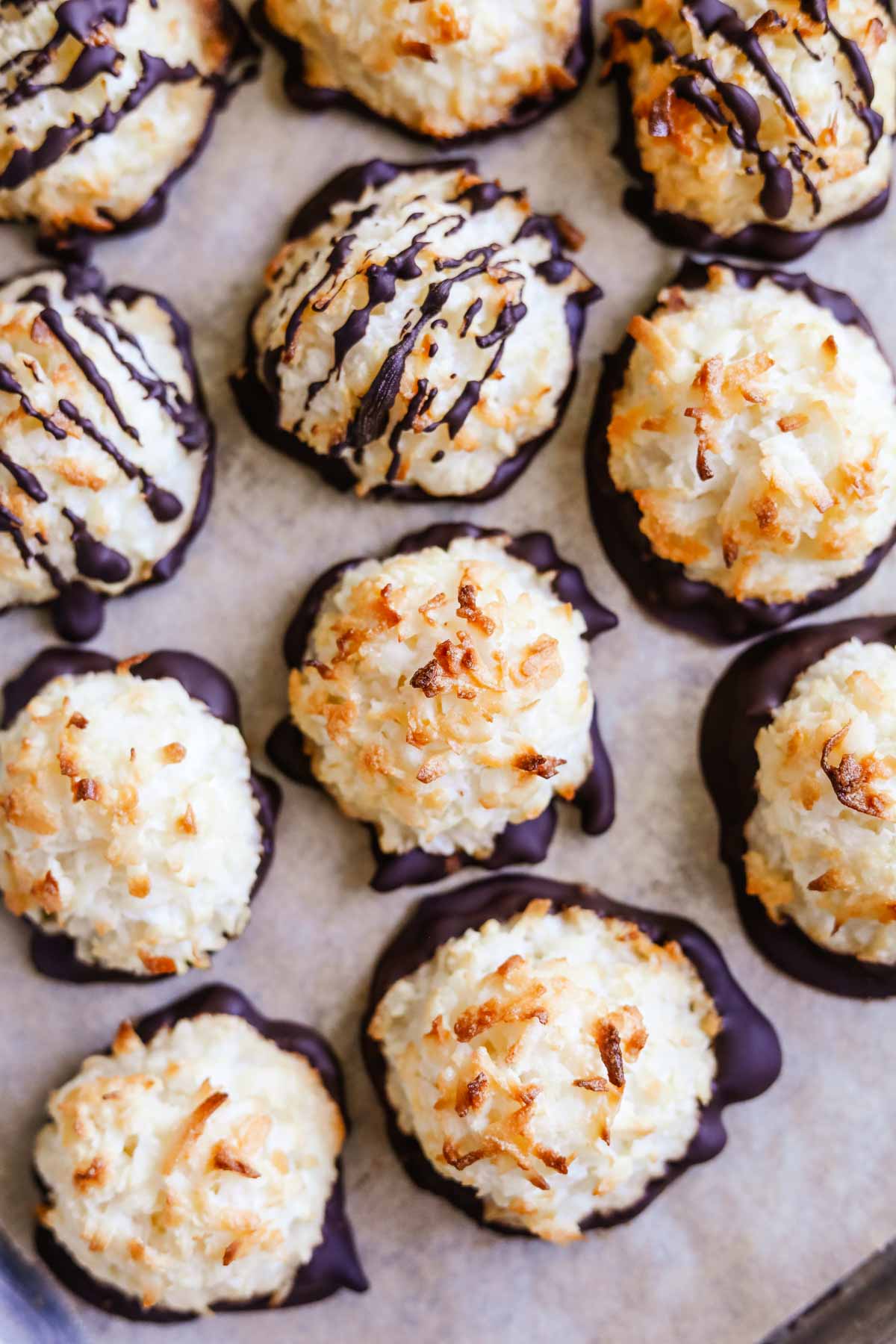 Gluten-free coconut macaroons without flour dipped and drizzled in semi-sweet chocolate.