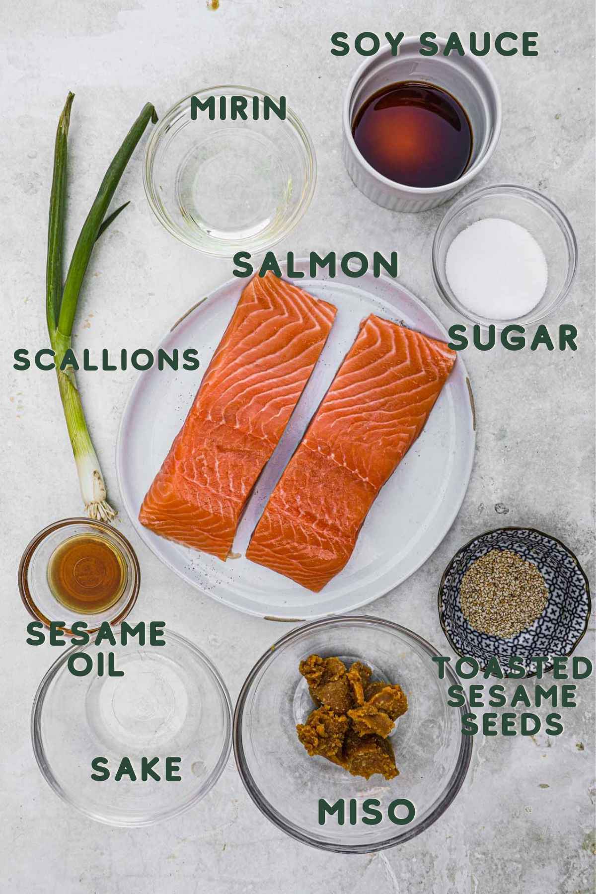 Ingredients to make Japanese broiled miso salmon, salmon filet, soy sauce, mirin, sugar, scallions, sesame oil, yellow or white miso, sake, sesame seeds.