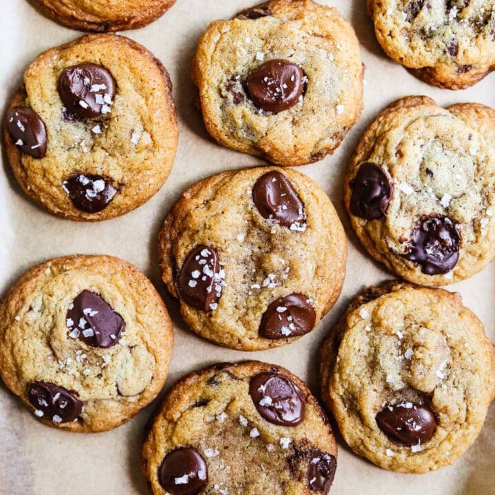 Small batch salted chocolate chip cookies on a parchment paper-lined sheet pan.