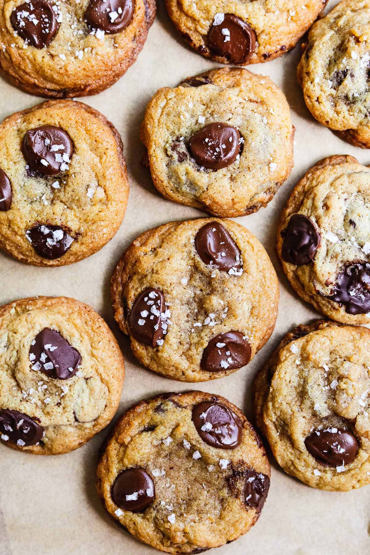 Small batch salted chocolate chip cookies on a parchment paper-lined sheet pan.