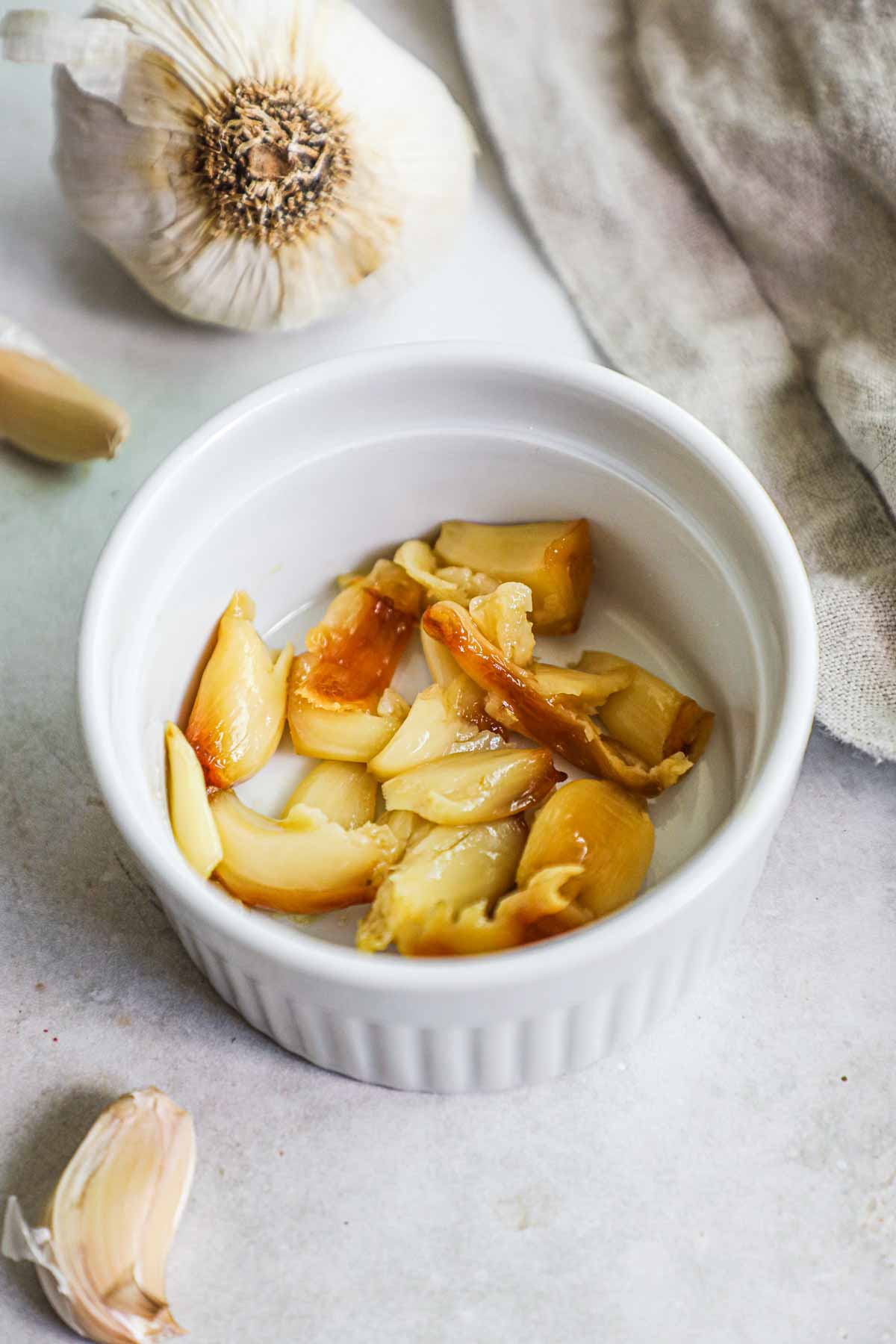Oven-roasted garlic removed from the garlic paper and served in a ramekin.