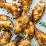Crispy oven-baked or oven-broiled chicken wings with golden crispy skin topped with fresh chopped Italian parsley.