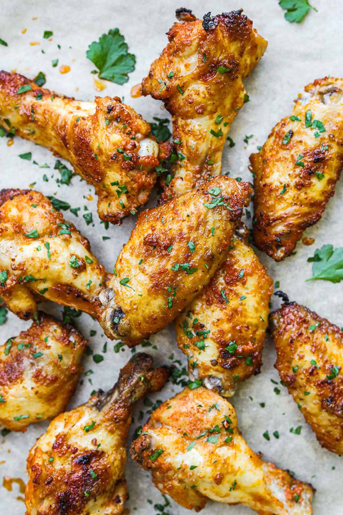 Crispy oven-baked or oven-broiled chicken wings with golden crispy skin topped with fresh chopped Italian parsley.