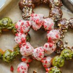Closeup of donuts with strawberry, Nutella chocolate, and matcha glaze.