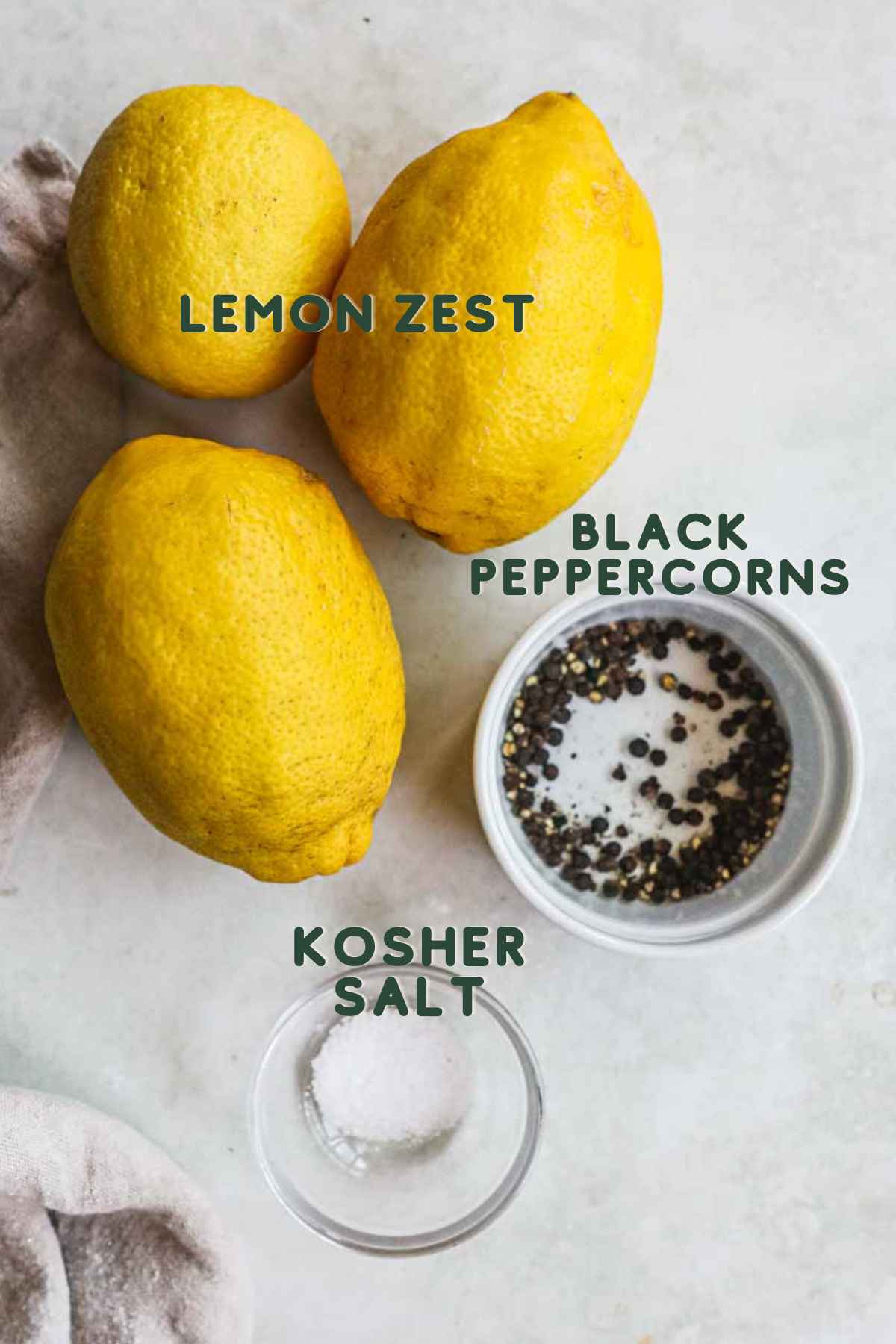 Ingredients to make lemon pepper seasoning, including lemon zest, black peppercorns, and kosher or sea salt.