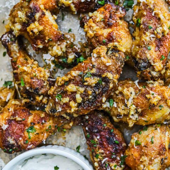 Garlic parmesan wings covered in garlic and parsley served with a creamy dipping sauce.