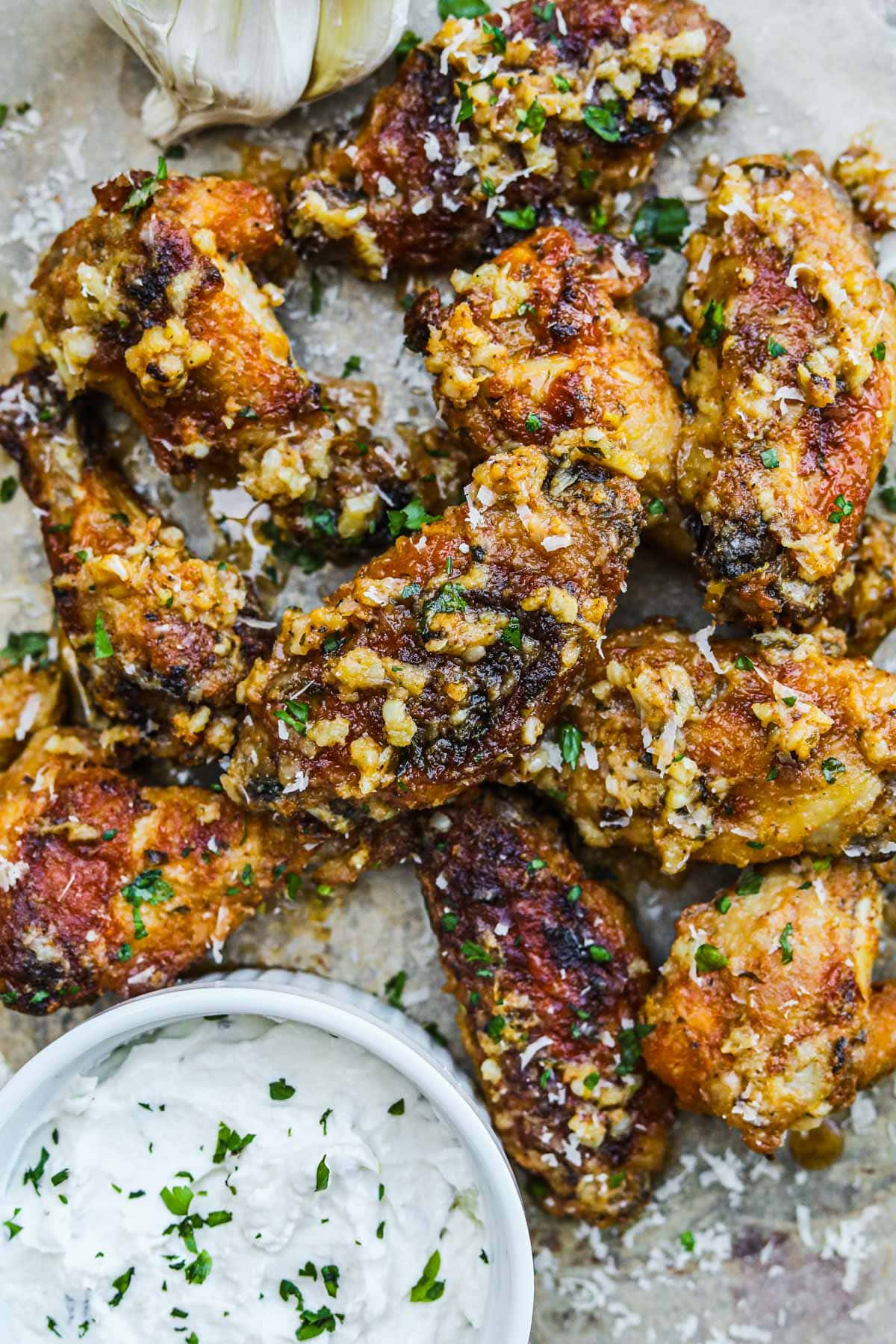 Garlic parmesan wings covered in garlic and parsley served with a creamy dipping sauce.