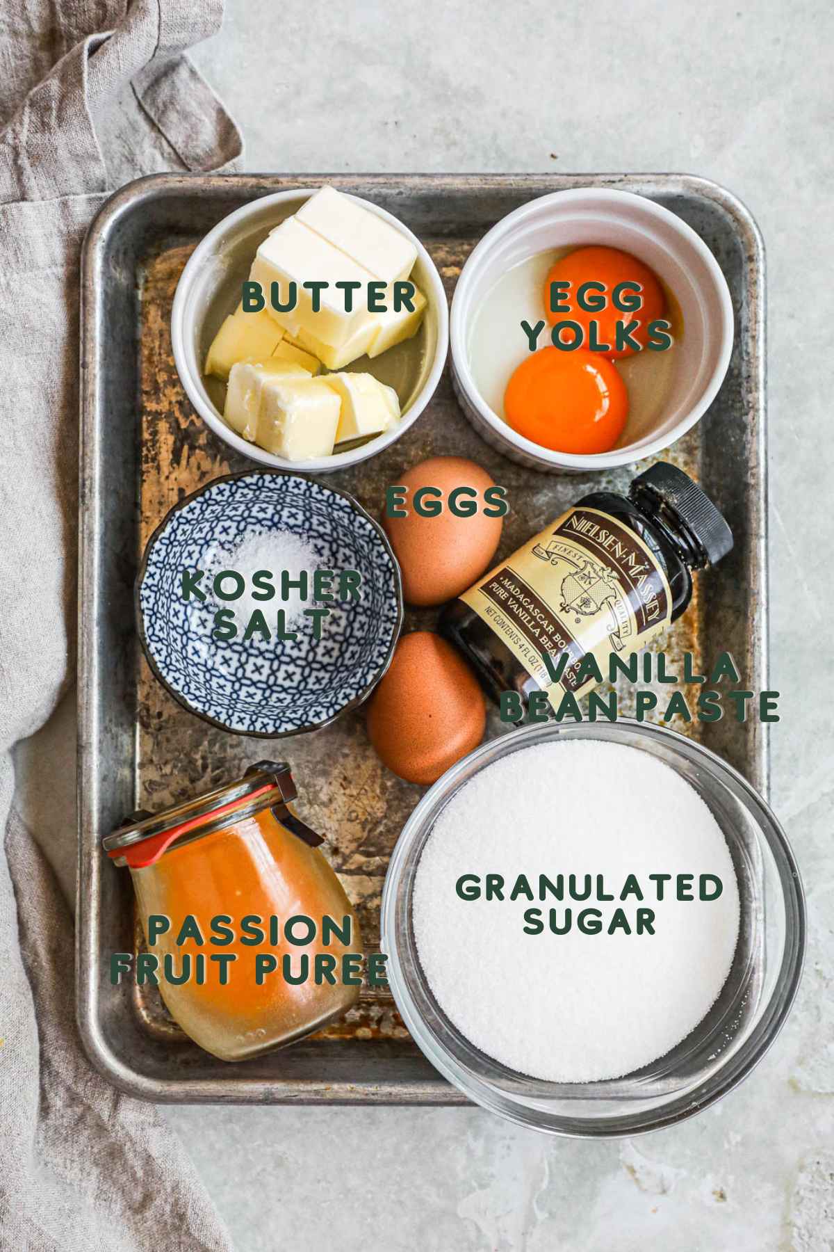 Ingredients for passion fruit curd (lilikoi butter), passion fruit puree, butter, eggs and yolks, vanilla bean paste, kosher salt, granulated sugar.
