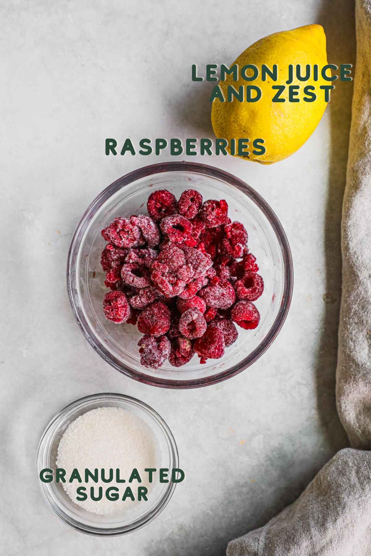 Ingredients to make raspberry compote, including raspberries, lemon juice and zest, and granulated sugar.